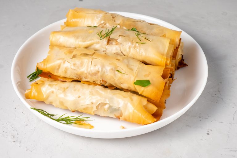 Puff pastry with filling in a plate. Burek